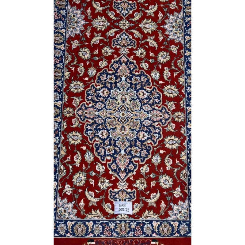 "Close-up of intricate floral pattern on red oriental rug runner from Isfahan"