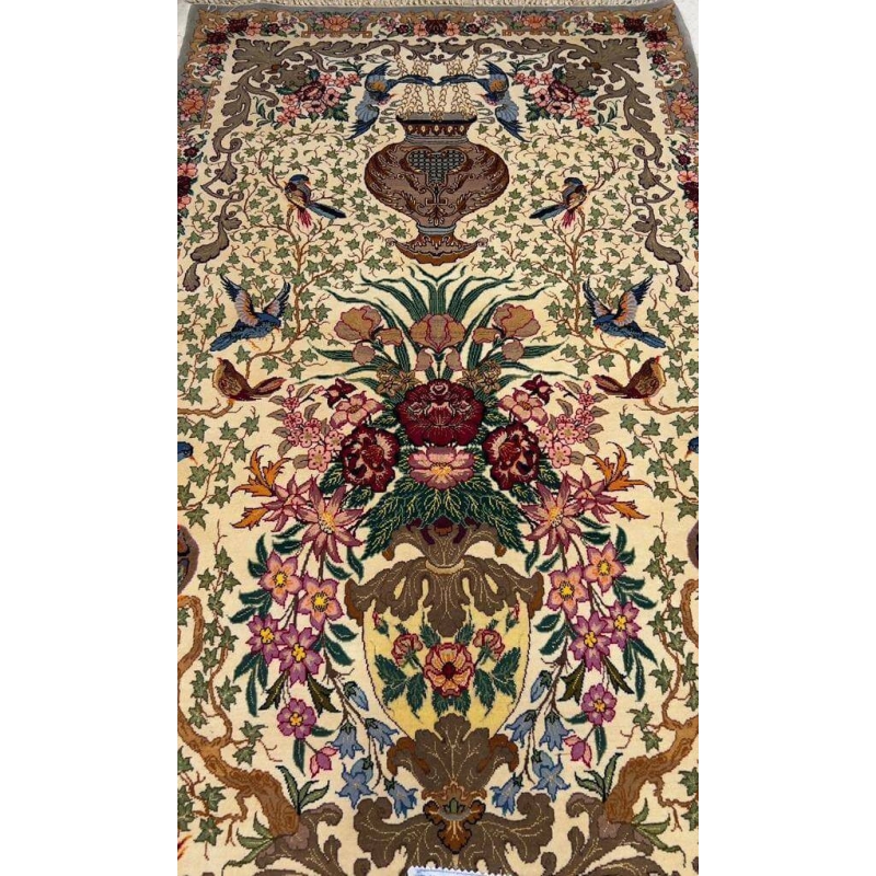 Close-up of the detailed floral craftsmanship on the luxury hand-knotted rug