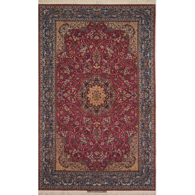 Antique Persian Rug by Ahmad Seirafian – A 75-year-old hand-knotted Isfahan rug featuring an intricate floral medallion on a rich red field, framed by an ornate blue and gold border, crafted from silk and wool.