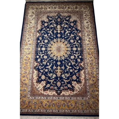 "Handmade Isfahan rug with a rich navy blue base, golden arabesque designs, and luxurious silk highlights."