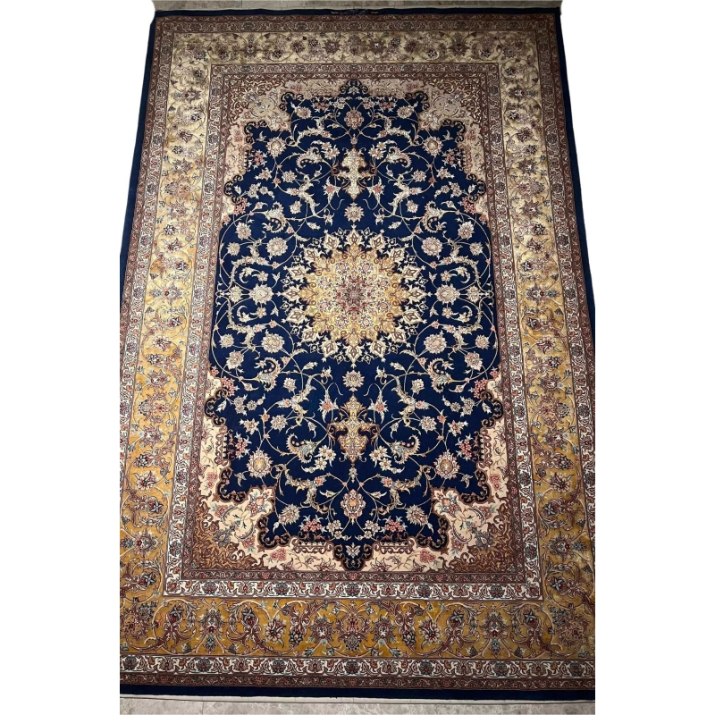 "Handmade Isfahan rug with a rich navy blue base, golden arabesque designs, and luxurious silk highlights."