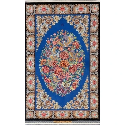 "Hand-knotted Isfahan Persian rug featuring an oval floral bouquet and flying birds on a deep blue silk base."