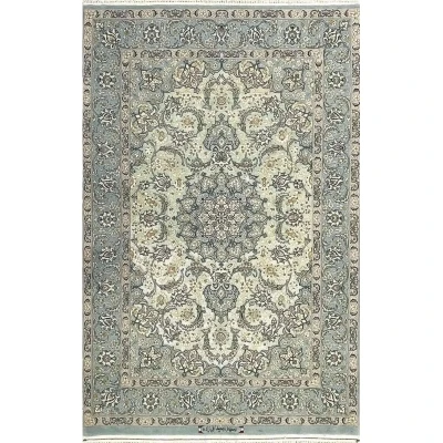 "Handmade Isfahan Persian rug with intricate floral medallion, crafted from fine silk and wool in soft blue and ivory."