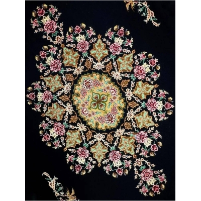 "Close-up of Persian rug featuring central medallion and floral designs."