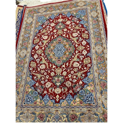 Persian rug featuring gold and red floral patterns, hand-knotted in Isfahan