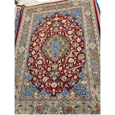 Persian rug featuring gold and red floral patterns, hand-knotted in Isfahan