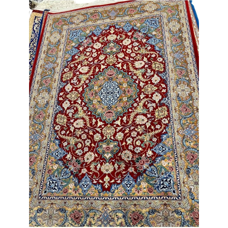 Persian rug featuring gold and red floral patterns, hand-knotted in Isfahan