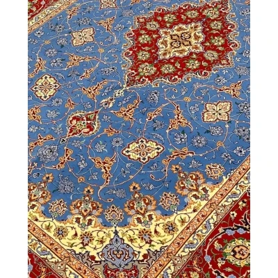 "Decorative wool and silk Persian rug, crafted by Saieed Davarie, with beautiful blue and red floral patterns, new and in stock."