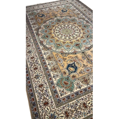"Luxurious wool and silk Persian rug in ivory, gold, and teal tones, crafted in Isfahan, Iran."