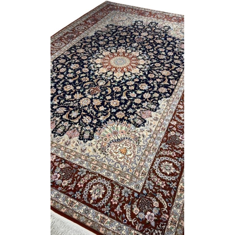 "Authentic Persian carpet from Isfahan, Iran, featuring a navy blue background and elaborate floral motifs."