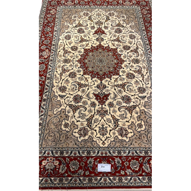 "Hand-knotted Persian Isfahan rug, crafted with silk and wool, featuring intricate traditional designs. Measuring 235 cm x 155 cm (7.7 ft x 5.1 ft) with a knot density of 810,000 knots per square meter. This luxurious handmade Persian rug adds timeless elegance to any space. Available for purchase online, with only one piece in stock."