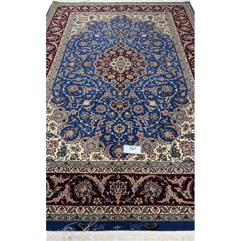 "Luxurious hand-knotted Persian carpet from Isfahan, Iran, with intricate floral motifs and silk highlights."