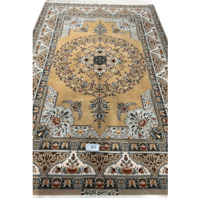 A detailed view of a luxurious Isfahan carpet with elaborate floral motifs and rich colors