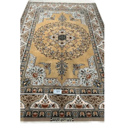 A detailed view of a luxurious Isfahan carpet with elaborate floral motifs and rich colors