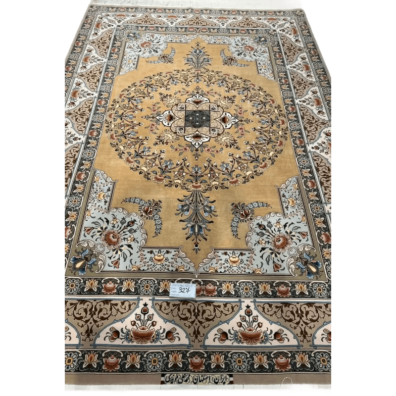 A detailed view of a luxurious Isfahan carpet with elaborate floral motifs and rich colors