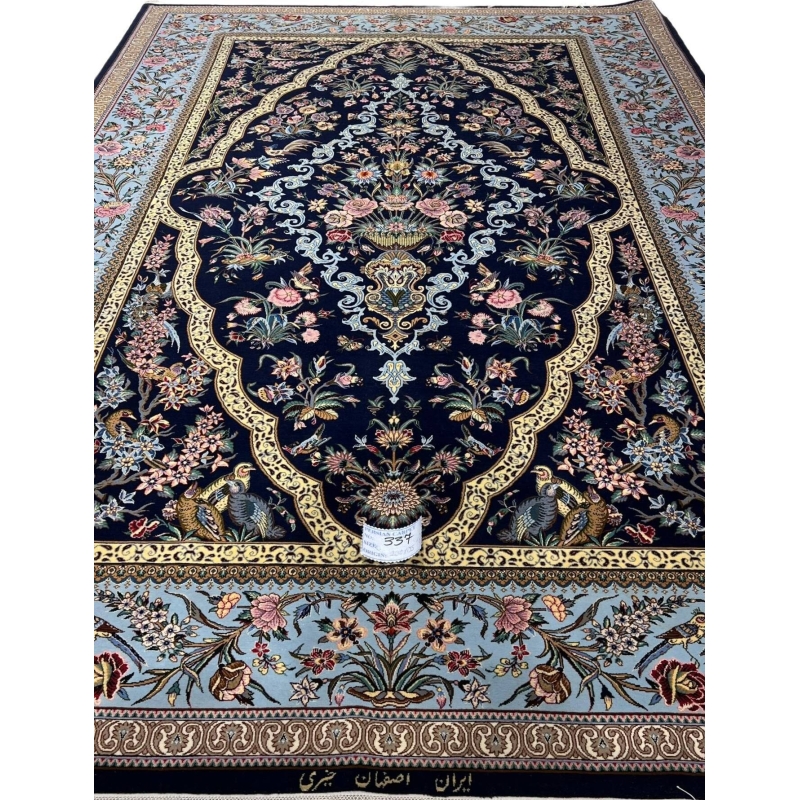 "Luxury hand-knotted Isfahan Persian rug featuring intricate floral and peacock motifs on a navy background."
