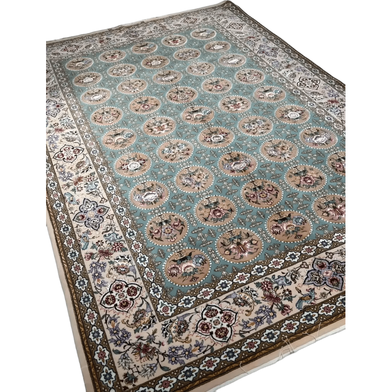 An Isfahan rug featuring intricate blue and green patterns framed by borders