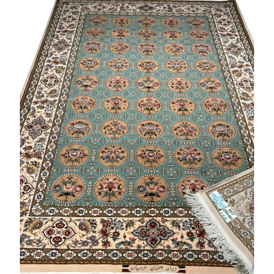 Close-up of a fully framed Isfahan rug showcasing its blue and green design elements