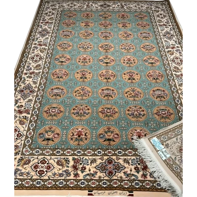 Close-up of a fully framed Isfahan rug showcasing its blue and green design elements