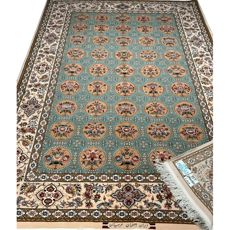 Close-up of a fully framed Isfahan rug showcasing its blue and green design elements