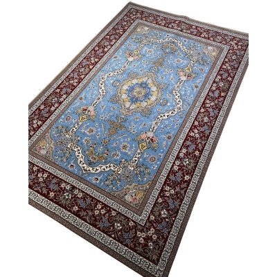 "Traditional Persian rug from Isfahan, featuring intricate medallion design with blue and burgundy accents, made of silk and wool."