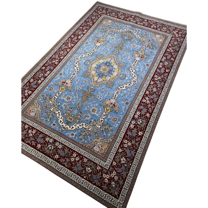 "Traditional Persian rug from Isfahan, featuring intricate medallion design with blue and burgundy accents, made of silk and wool."