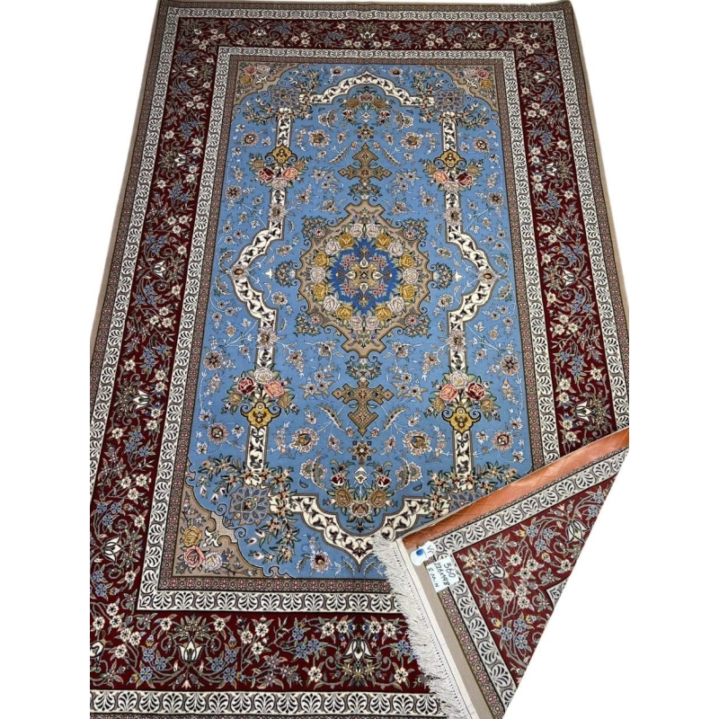 "Hand-knotted Persian Isfahan rug with a light blue floral field and burgundy border, crafted by Mansourie."
