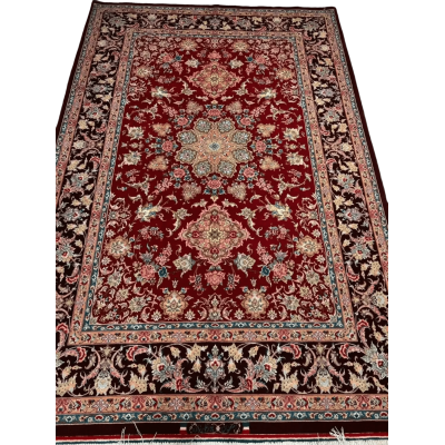 An Isfahan Persian rug featuring intricate red and blue patterns