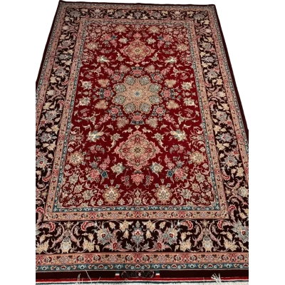 An Isfahan Persian rug featuring intricate red and blue patterns