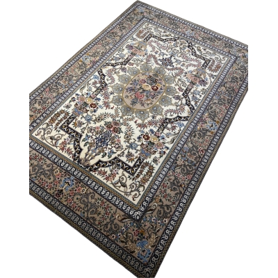 "Isfahan hand-knotted rug with a floral medallion centerpiece and ornate border design."