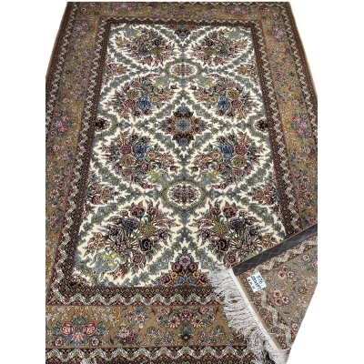 "215 x 145 cm wool and silk carpet with intricate floral patterns."