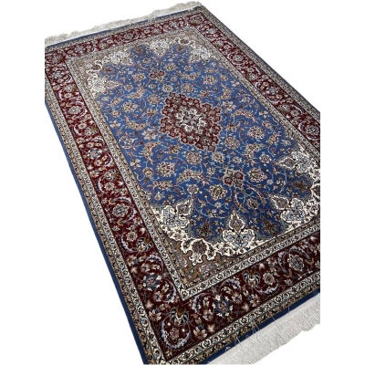 "Detail of traditional Persian motifs in hand-knotted Isfahan rug, crafted by master weaver Hossein Davarie."