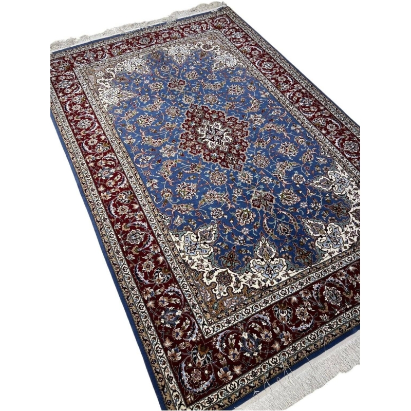 "Detail of traditional Persian motifs in hand-knotted Isfahan rug, crafted by master weaver Hossein Davarie."