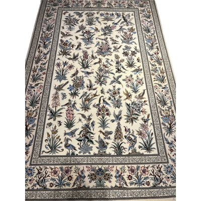 "Handmade Isfahan Persian rug with floral and bird design, crafted from silk and wool for a luxurious touch."