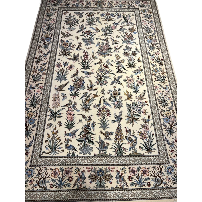"Handmade Isfahan Persian rug with floral and bird design, crafted from silk and wool for a luxurious touch."