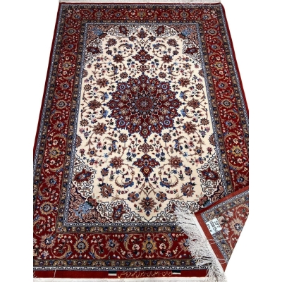 "Isfahan rug with a silk warp and 640,000 knots per square meter, featuring red tones."