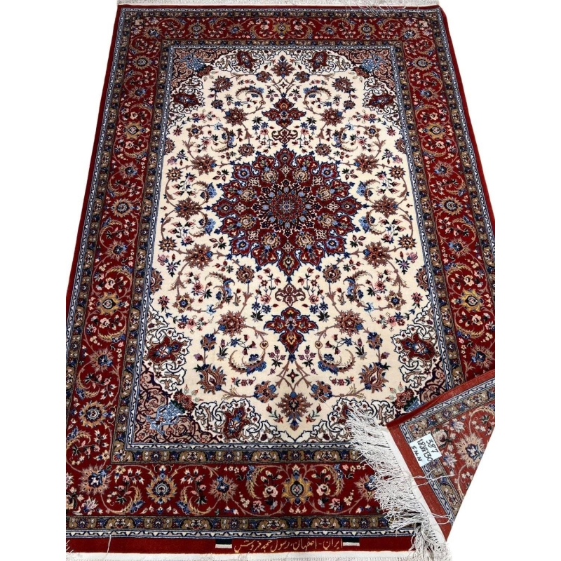 "Isfahan rug with a silk warp and 640,000 knots per square meter, featuring red tones."