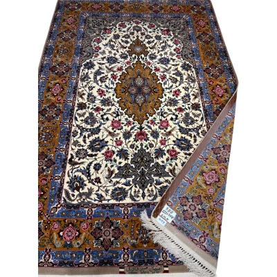 Hand-knotted wool and silk rug in ivory, royal blue, and gold tones.