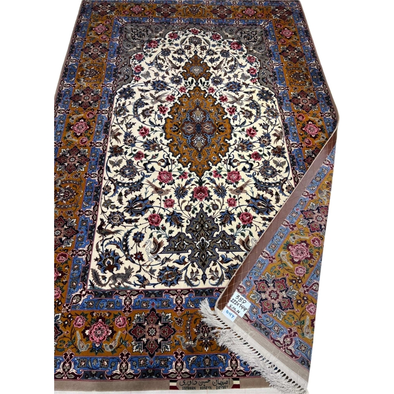 Hand-knotted wool and silk rug in ivory, royal blue, and gold tones.