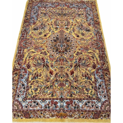 "Handwoven Isfahan Persian rug with golden phoenix design and intricate floral medallion, crafted from silk and wool."