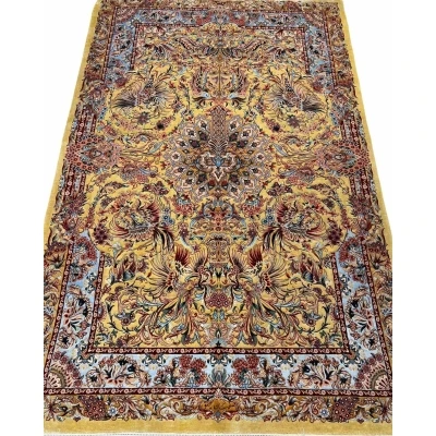 "Handwoven Isfahan Persian rug with golden phoenix design and intricate floral medallion, crafted from silk and wool."