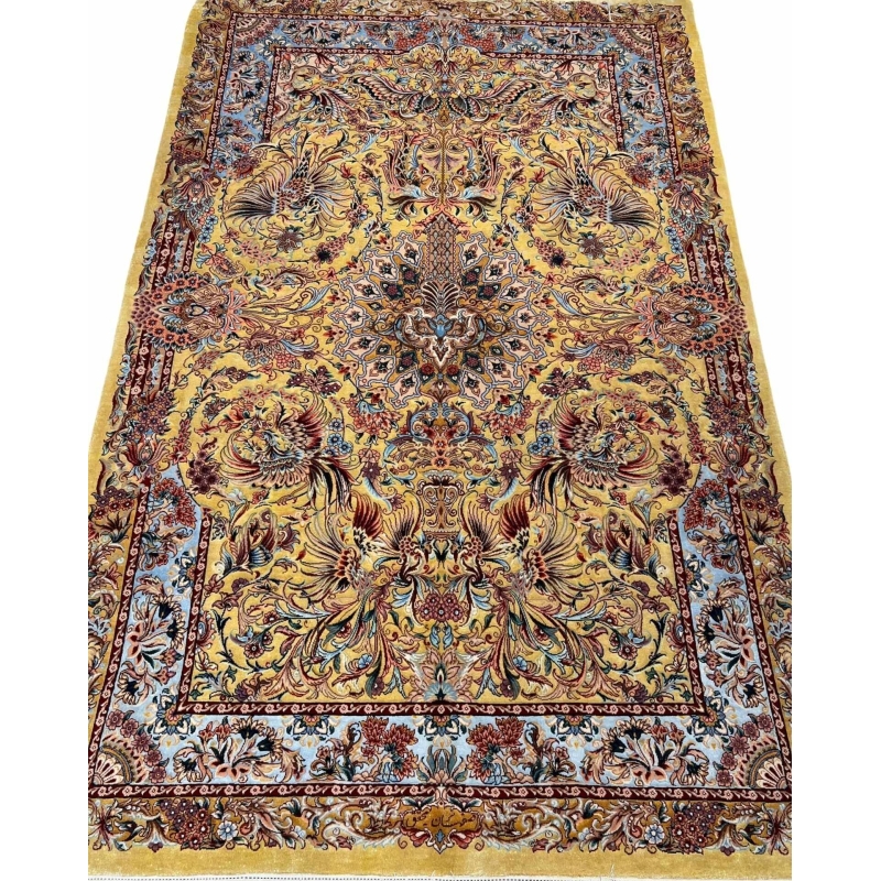 "Handwoven Isfahan Persian rug with golden phoenix design and intricate floral medallion, crafted from silk and wool."