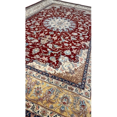 "Exquisite silk and wool Persian carpet – luxury hand-knotted Isfahan rug in red, gold, and beige tones."
