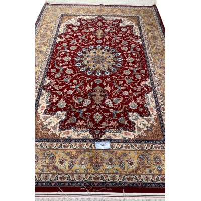 "Luxury Persian wool and silk rug with a classic red and gold design, perfect for sophisticated interiors."