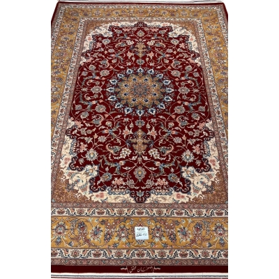 "Handmade Isfahan Persian rug with deep red medallion design, crafted from silk and wool for a luxurious touch."