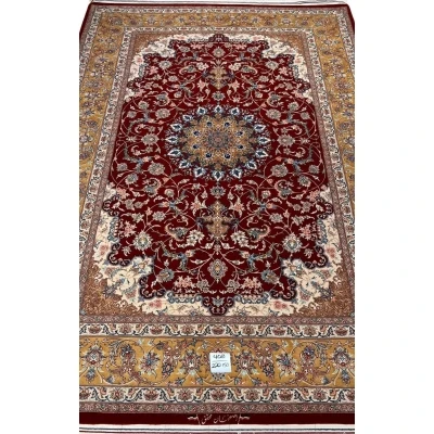 "Handmade Isfahan Persian rug with deep red medallion design, crafted from silk and wool for a luxurious touch."