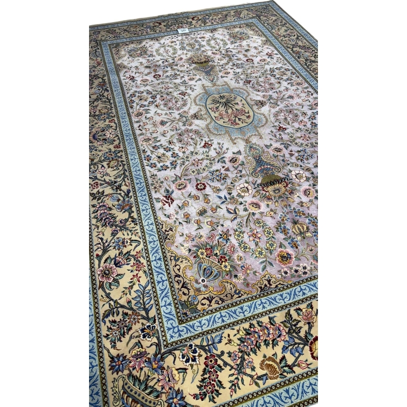 "Handmade Persian Isfahan rug featuring a detailed flower vase design and vibrant blue borders."