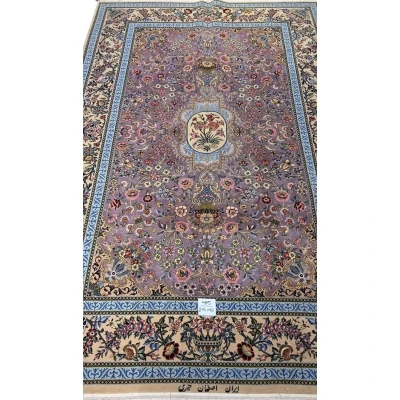 "Elegant Persian rug with intricate floral motifs on a lilac base, hand-knotted by Kheire, 215 x 140 cm."
