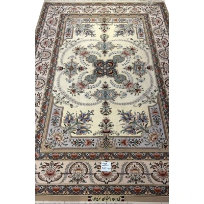 "Persian Isfahan rug with intricate floral and geometric patterns, hand-knotted by Master Moaeedie in silk and wool."
