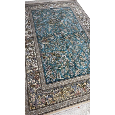 "Handmade Persian carpet from Isfahan – elegant silk and wool area rug with detailed Persian hunting design."